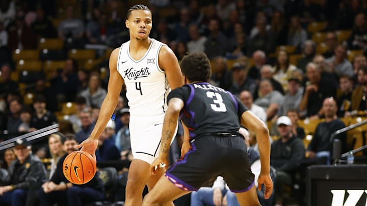 Central Florida Knights guard Keyshawn Hall (4) looks to pass as Texas Christian Horned Frogs guard Vasean Allette (3) defends at Addition Financial Arena. 