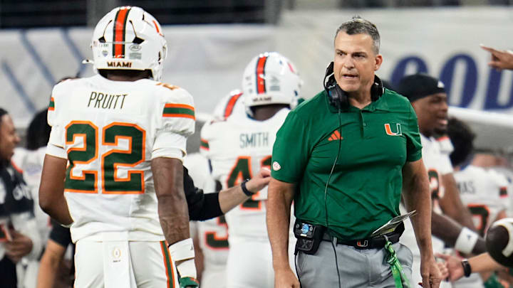 Miami Hurricanes head coach Mario Cristobal reacts beside linebacker Cameron Pruitt (22) during the Cotton Bowl at AT&T Stadium in Arlington, Texas for the College Football Playoff quarterfinal game against the Ohio State Buckeyes on Dec. 31, 2025.