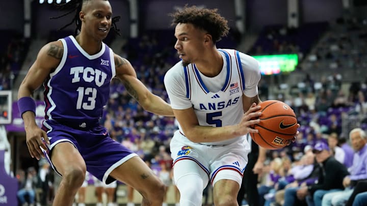 Jan 22, 2025; Fort Worth, Texas, USA;  Kansas Jayhawks guard Zeke Mayo (5) controls the ball as TCU Horned Frogs forward Trazarien White (13) defends during the second half at Ed and Rae Schollmaier Arena. Mandatory Credit: Chris Jones-Imagn Images