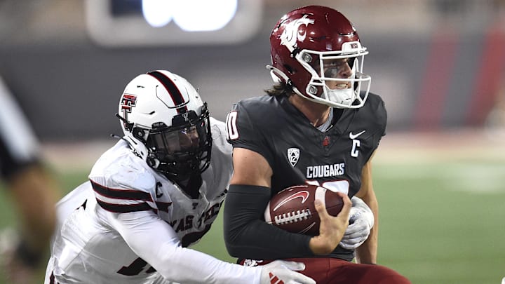 Sep 7, 2024; Pullman, Washington, USA; Washington State Cougars quarterback John Mateer, right, is caught from behind by Texas Tech Red Raiders linebacker Jacob Rodriguez (10) in the second half at Gesa Field at Martin Stadium. Washington State Cougars won 37-16. Mandatory Credit: James Snook-Imagn Images