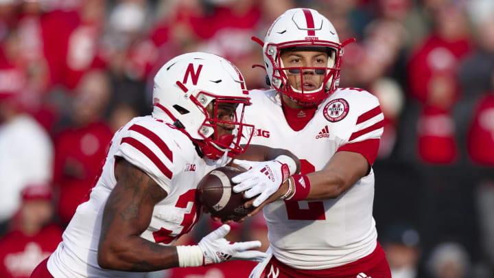 Nov 20, 2021; Madison, Wisconsin, USA; Nebraska Cornhuskers quarterback Adrian Martinez (2) hands the football off to running back Markese Stepp (30) during the first quarter against the Wisconsin Badgers at Camp Randall Stadium. Nov 20, 2021; Madison, Wisconsin, USA; Nebraska Cornhuskers quarterback Adrian Martinez (2) hands the football off to running back Markese Stepp (30) during the first quarter against the Wisconsin Badgers at Camp Randall Stadium.