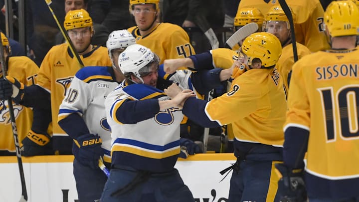 Mar 27, 2025; Nashville, Tennessee, USA;  Nashville Predators defenseman Andreas Englund (8) connects to St. Louis Blues center Zack Bolduc (76) during the second period at Bridgestone Arena. Mandatory Credit: Steve Roberts-Imagn Images