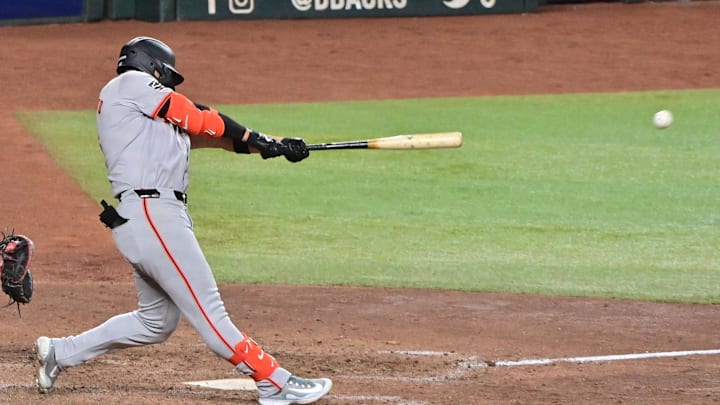 Sep 23, 2024; Phoenix, Arizona, USA;  San Francisco Giants outfielder Michael Conforto (8) doubles in the seventh inning against the Arizona Diamondbacks at Chase Field.