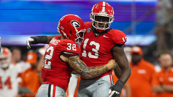 Georgia Bulldogs defensive lineman Mykel Williams (13) celebrates after a tackle with linebacker Chaz Chambliss (32)