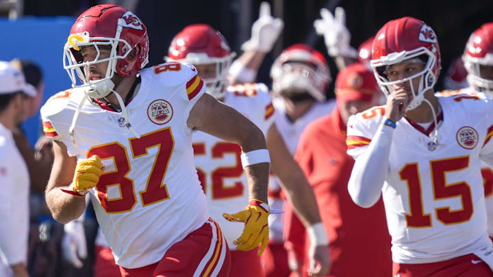 Nov 24, 2024; Charlotte, North Carolina, USA; Kansas City Chiefs tight end Travis Kelce (87) and quarterback Patrick Mahomes (15) lead their team onto the field against the Carolina Panthers during the first quarter at Bank of America Stadium. Mandatory Credit: Jim Dedmon-Imagn Images