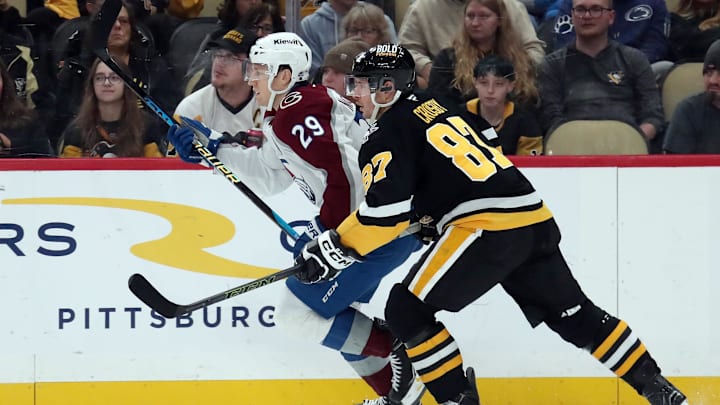 Dec 10, 2024; Pittsburgh, Pennsylvania, USA;  Colorado Avalanche center Nathan MacKinnon (29) and Pittsburgh Penguins center Sidney Crosby (87) in action during the first period at PPG Paints Arena. Mandatory Credit: Charles LeClaire-Imagn Images