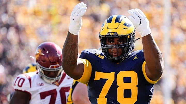 Michigan defensive lineman Kenneth Grant (78) celebrates a tackle against USC during the first half at Michigan Stadium in Ann Arbor . Michigan defensive lineman Kenneth Grant (78) celebrates a tackle against USC during the first half at Michigan Stadium in Ann Arbor .