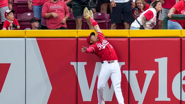 Cincinnati Reds third baseman Noelvi Marte (16) leaps to rob a home run over the wall from Pittsburgh Pirates right fielder Bryan Reynolds (10) in the ninth inning of the MLB National League game between the Cincinnati Reds and the Pittsburgh Pirates at Great American Ball Park in downtown Cincinnati on Thursday, Sept. 25, 2025. The Reds won, 2-1.