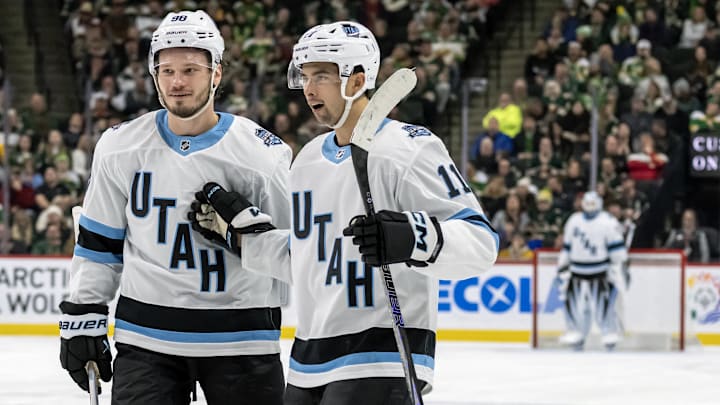 Dec 20, 2024; Saint Paul, Minnesota, USA;  Utah Hockey Club forward Dylan Guenther (11) celebrates his power play goal against the Minnesota Wild with defenseman Mikhail Sergachev (98) during the third period at Xcel Energy Center. Mandatory Credit: Nick Wosika-Imagn Images