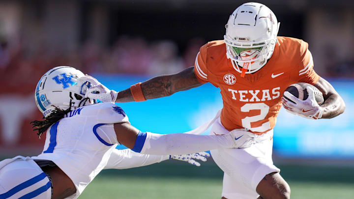 Texas Longhorns wide receiver Matthew Golden (2) stiff arms Kentucky Wildcats defensive back Maxwell Hairston (1) in the first quarter of an NCAA college football game at Darrell K Royal Texas Memorial Stadium in Austin, Texas on Saturday, Nov. 24, 2024.