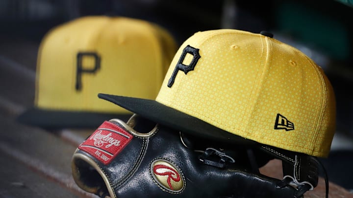 Sep 16, 2023; Pittsburgh, Pennsylvania, USA;  Pittsburgh Pirates hats and gloves in the dugout against the New York Yankees during the sixth inning at PNC Park. Mandatory Credit: Charles LeClaire-Imagn Images