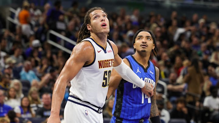 Nov 22, 2023; Orlando, Florida, USA; Denver Nuggets forward Aaron Gordon (50) and Orlando Magic guard Gary Harris (14) look for the rebound during the second half at Amway Center. Mandatory Credit: Mike Watters-Imagn Images