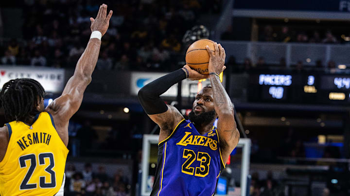 Mar 29, 2024; Indianapolis, Indiana, USA; Los Angeles Lakers forward LeBron James (23) shoots the ball while Indiana Pacers forward Aaron Nesmith (23) defends in the second half at Gainbridge Fieldhouse. Mandatory Credit: Trevor Ruszkowski-Imagn Images