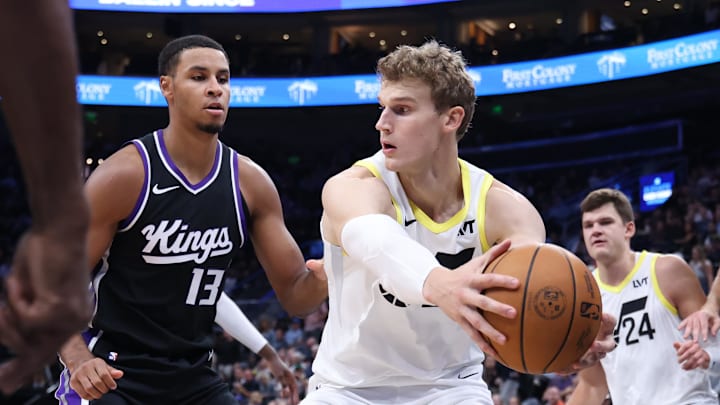 Oct 15, 2024; Salt Lake City, Utah, USA; Utah Jazz forward Lauri Markkanen (23) holds the ball away from Sacramento Kings forward Keegan Murray (13) during the third quarter at Delta Center. Mandatory Credit: Rob Gray-Imagn Images