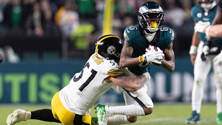 Dec 15, 2024; Philadelphia, Pennsylvania, USA; Philadelphia Eagles wide receiver DeVonta Smith (6) makes a catch past Pittsburgh Steelers linebacker Nick Herbig (51) during the third quarter at Lincoln Financial Field. Mandatory Credit: Bill Streicher-Imagn Images
