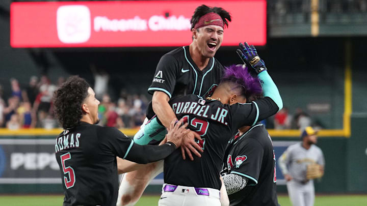 Apr 12, 2025; Phoenix, Arizona, USA; Arizona Diamondbacks outfielder Alek Thomas (5) and Arizona Diamondbacks outfielder Corbin Carroll (7) celebrate with Arizona Diamondbacks outfielder Lourdes Gurriel Jr. (12)  after a walk-off sacrifice fly RBI by Gurriel Jr. against the Milwaukee Brewers during the ninth inning at Chase Field. Mandatory Credit: Joe Camporeale-Imagn Images
