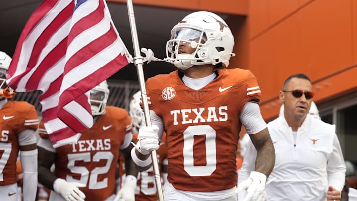 Sep 6, 2025; Austin, Texas, USA; Texas Longhorns wide receiver DeAndre Moore Jr. (0) leads players on to the field before the game against the San Jose State Spartans at Darrell K Royal-Texas Memorial Stadium. Mandatory Credit: Scott Wachter-Imagn Images