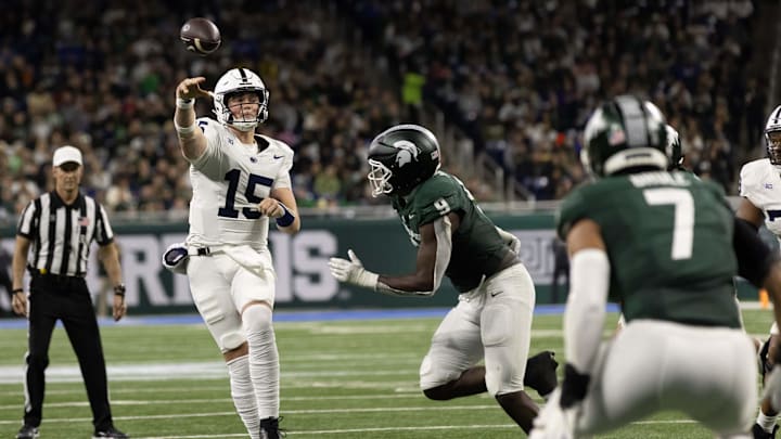 Nov 24, 2023; Detroit, Michigan, USA; Penn State Nittany Lions quarterback Drew Allar (15) passes the ball while pressured by Michigan State Spartans defensive lineman Zion Young (9) during the first half at Ford Field. Mandatory Credit: David Reginek-Imagn Images Nov 24, 2023; Detroit, Michigan, USA; Penn State Nittany Lions quarterback Drew Allar (15) passes the ball while pressured by Michigan State Spartans defensive lineman Zion Young (9) during the first half at Ford Field. Mandatory Credit: David Reginek-Imagn Images