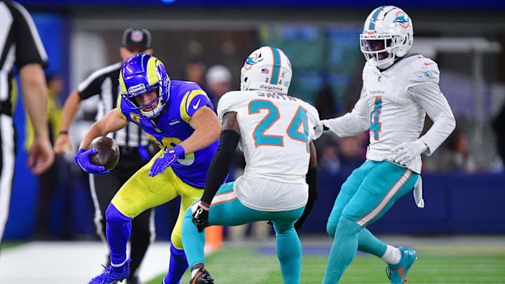 Los Angeles Rams wide receiver Cooper Kupp (10) runs the ball against Miami Dolphins cornerback Cam Smith (24) and cornerback Kader Kohou (4) during the second half at SoFi Stadium.