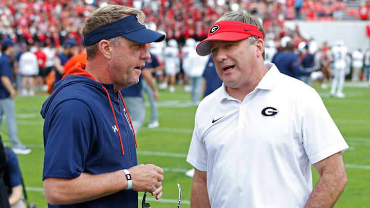 Auburn head coach Hugh Freeze speaks with Georgia head coach Kirby Smart before the start of a NCAA college football game in Athens, Ga., on Saturday, Oct. 5, 2024.
