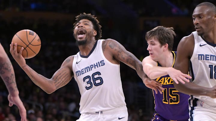 Jan 5, 2024; Los Angeles, California, USA; Memphis Grizzlies guard Marcus Smart (36) is fouled by Los Angeles Lakers guard Austin Reaves (15) in the second half at Crypto.com Arena. Mandatory Credit: Jayne Kamin-Oncea-Imagn Images