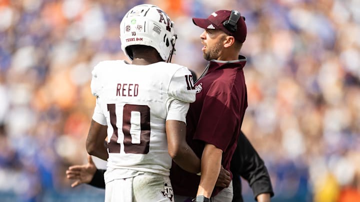 Sep 14, 2024; Gainesville, Florida, USA; Texas A&M Aggies quarterback Marcel Reed (10) celebrates with Texas A&M Aggies offensive coordinator Collin Klein after a touchdown against the Florida Gators during the first half at Ben Hill Griffin Stadium. Mandatory Credit: Matt Pendleton-Imagn Images Sep 14, 2024; Gainesville, Florida, USA; Texas A&M Aggies quarterback Marcel Reed (10) celebrates with Texas A&M Aggies offensive coordinator Collin Klein after a touchdown against the Florida Gators during the first half at Ben Hill Griffin Stadium. Mandatory Credit: Matt Pendleton-Imagn Images