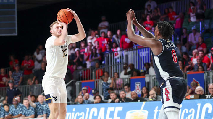 Nov 29, 2024; Paradise Island, Bahamas, BHS;  West Virginia Mountaineers guard Tucker DeVries (12) shoots over Arizona Wildcats guard Jaden Bradley (0) during the second half at Imperial Arena at the Atlantis resort.  Mandatory Credit: Kevin Jairaj-Imagn Images