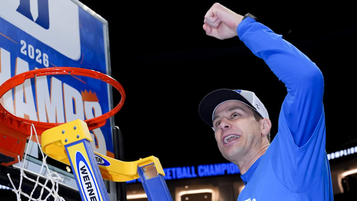 Mar 14, 2026; Charlotte, NC, USA; Duke Blue Devils head coach Jon Scheyer cuts down the net after defeating the Virginia Cavaliers in the men's ACC Conference Tournament Championship.