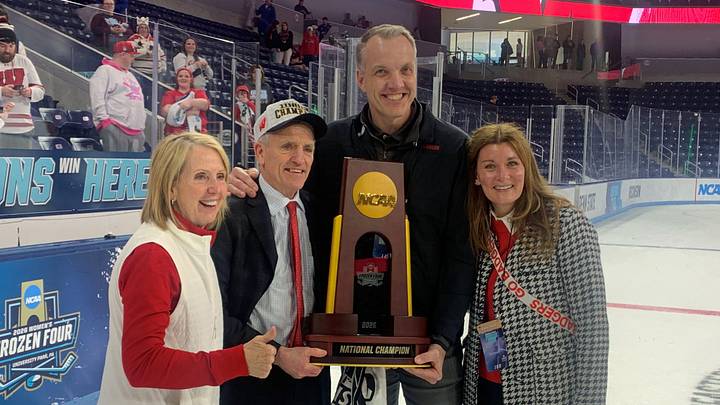 Wisconsin coach Mark Johnson and athletic director Chris McIntosh pose with the championship trophy after the Badgers won the NCAA women's hockey championship at Pegula Ice Arena in University Park, Pa. on March 22, 2026