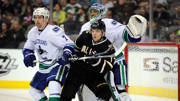 Feb 26, 2012; Dallas, TX, USA; Dallas Stars center Toby Petersen (17) screens Vancouver Canucks goalie Roberto Luongo (1) as left wing David Booth (7) defends during the second period at the American Airlines Center. Mandatory Credit: Jerome Miron-Imagn Images