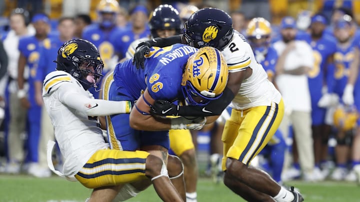 Oct 12, 2024; Pittsburgh, Pennsylvania, USA;  California Golden Bears defensive back Miles Williams (left) and defensive back Craig Woodson (2) tackle Pittsburgh Panthers tight end Gavin Bartholomew (86) during the fourth quarter against at Acrisure Stadium. Pittsburgh won 17-15. Mandatory Credit: Charles LeClaire-Imagn Images