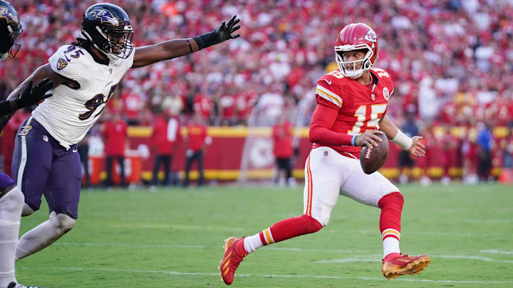 Sep 28, 2025; Kansas City, Missouri, USA;  Kansas City Chiefs quarterback Patrick Mahomes (15) looks to pass as Baltimore Ravens linebacker Tavius Robinson (95) defends at GEHA Field at Arrowhead Stadium. Mandatory Credit: Denny Medley-Imagn Images