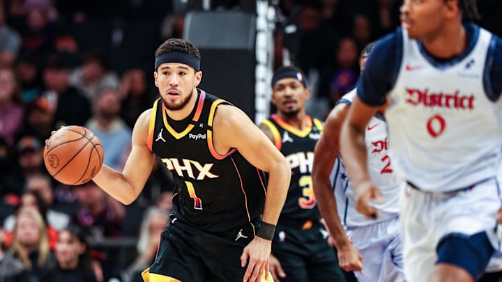Jan 25, 2025; Phoenix, Arizona, USA; Phoenix Suns guard Devin Booker (1) dribbles the ball during the first quarter against the Washington Wizards at Footprint Center. Mandatory Credit: Aryanna Frank-Imagn Images
