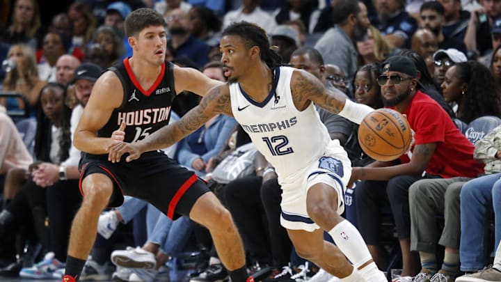 Nov 5, 2025; Memphis, Tennessee, USA; Memphis Grizzlies guard Ja Morant (12) dribbles as Houston Rockets guard Reed Sheppard (15) defends during the fourth quarter at FedExForum. Mandatory Credit: Petre Thomas-Imagn Images