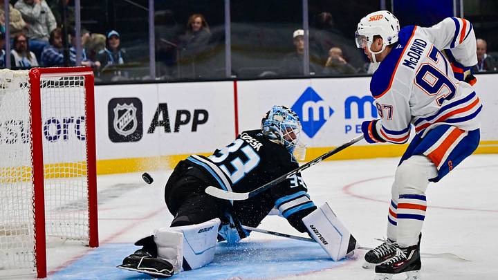 Oct 17, 2026; Salt Lake City, Utah, USA;  Edmonton Oilers center Connor McDavid (97) scores a goal on Utah Mammoth goalie Sebastian Cossa (33) during third period at Delta Center.  Mandatory Credit: Peter Creveling-Imagn Images