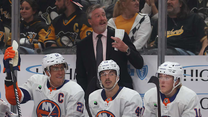 Oct 9, 2025; Pittsburgh, Pennsylvania, USA;  New York Islanders head coach Patrick Roy (rear) gestures on the bench against the Pittsburgh Penguins during the third period at PPG Paints Arena. Mandatory Credit: Charles LeClaire-Imagn Images