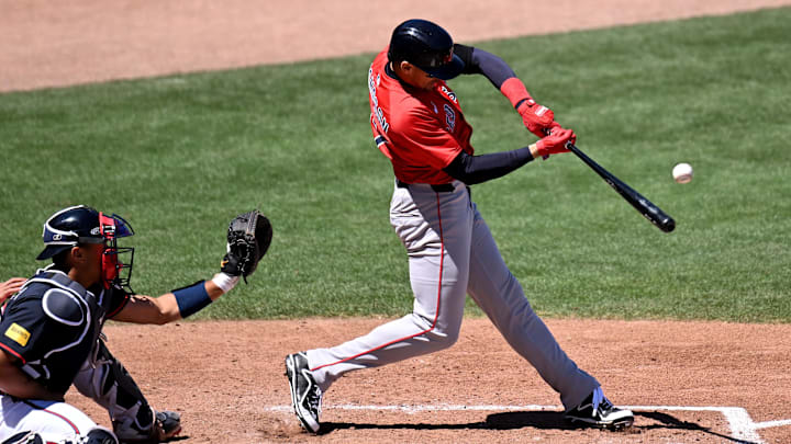Mar 17, 2025; North Port, Florida, USA; Boston Red Sox right fielder Trayce Thompson (37) hits a line drive in the fifth inning against the Atlanta Braves  during spring training at CoolToday Park. Mandatory Credit: Jonathan Dyer-Imagn Images