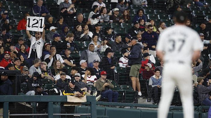 A Chicago White Sox spectator holds a sign to signal what the MLB record is for the most losses in a single season.