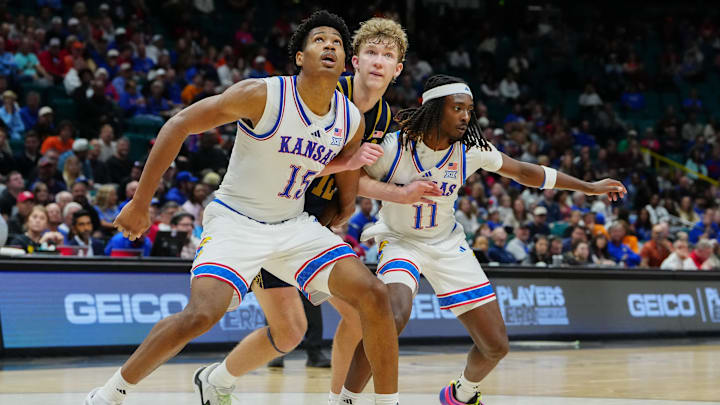 Nov 24, 2025; Las Vegas, Nevada, USA; Kansas Jayhawks forward Bryson Tiller (15) and guard Jamari McDowell (11) box out Notre Dame Fighting Irish forward Garrett Sundra (12) during the second half in a 2025 Players Era Festival group play game at MGM Grand Garden Arena. Mandatory Credit: Stephen R. Sylvanie-Imagn Images Nov 24, 2025; Las Vegas, Nevada, USA; Kansas Jayhawks forward Bryson Tiller (15) and guard Jamari McDowell (11) box out Notre Dame Fighting Irish forward Garrett Sundra (12) during the second half in a 2025 Players Era Festival group play game at MGM Grand Garden Arena. Mandatory Credit: Stephen R. Sylvanie-Imagn Images