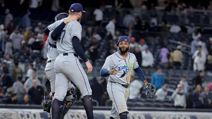 Sep 22, 2026; Bronx, New York, USA; Tampa Bay Rays third baseman Junior Caminero (13) celebrates with catcher Nick Fortes (40) and relief pitcher Bryan Baker (47) after defeating the New York Yankees at Yankee Stadium to clinch the American League East division title. Mandatory Credit: Brad Penner-Imagn Images Sep 22, 2026; Bronx, New York, USA; Tampa Bay Rays third baseman Junior Caminero (13) celebrates with catcher Nick Fortes (40) and relief pitcher Bryan Baker (47) after defeating the New York Yankees at Yankee Stadium to clinch the American League East division title. Mandatory Credit: Brad Penner-Imagn Images