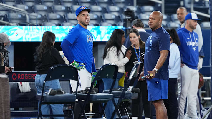 Toronto Blue Jays right fielder George Springer talks with former player Vernon Wells.