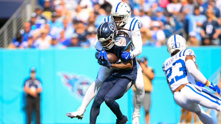 Oct 13, 2024; Nashville, Tennessee, USA;  Indianapolis Colts cornerback Jaylon Jones (40) tackles Tennessee Titans wide receiver DeAndre Hopkins (10) after a made catch during the first half at Nissan Stadium. Mandatory Credit: Steve Roberts-Imagn Images
