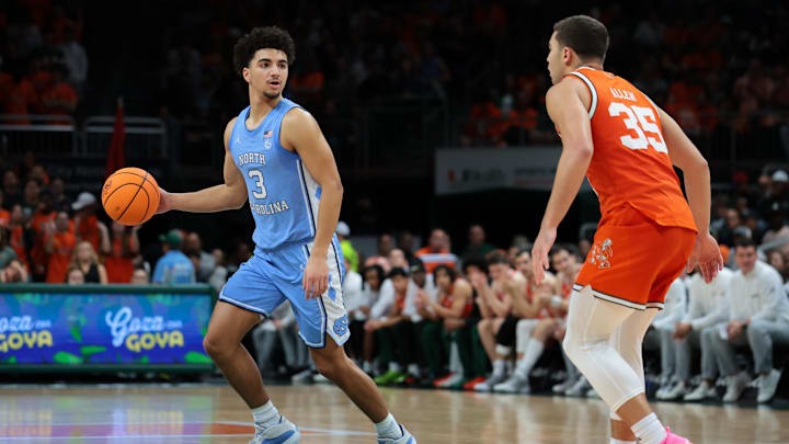 Feb 10, 2026; Coral Gables, Florida, USA; North Carolina Tar Heels guard Derek Dixon (3) dribbles the basketball as Miami Hurricanes guard Dante Allen (35) defends during the second half at Watsco Center. Mandatory Credit: Sam Navarro-Imagn Images Feb 10, 2026; Coral Gables, Florida, USA; North Carolina Tar Heels guard Derek Dixon (3) dribbles the basketball as Miami Hurricanes guard Dante Allen (35) defends during the second half at Watsco Center. Mandatory Credit: Sam Navarro-Imagn Images