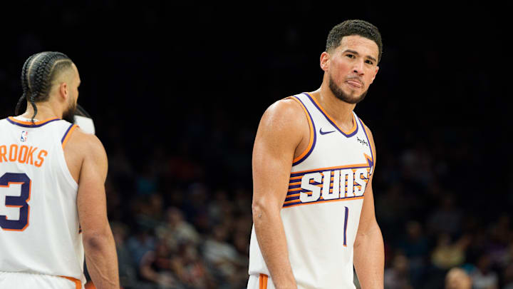 Phoenix Suns guard Devin Booker (1) reacts and sticks out his tung after a foul is called against the Suns during the second half of a game against the Atlanta Hawks at Mortgage Matchup Center. Mandatory Credit: Allan Henry-Imagn Images