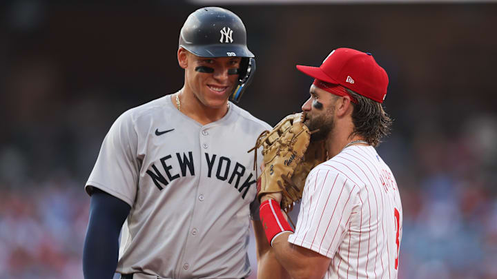 Jul 30, 2024; Philadelphia, Pennsylvania, USA; New York Yankees outfielder Aaron Judge (99) with Philadelphia Phillies first base Bryce Harper (3) on first base after his single during the first inning at Citizens Bank Park. Mandatory Credit: Bill Streicher-Imagn Images