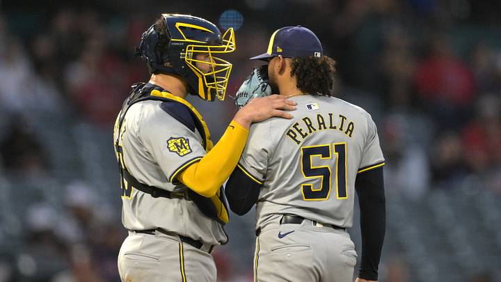 Jun 19, 2024; Anaheim, California, USA;  Milwaukee Brewers catcher Gary Sanchez (99) talks with starting pitcher Freddy Peralta (51) on the mound in the sixth inning against the Los Angeles Angels at Angel Stadium. Mandatory Credit: Jayne Kamin-Oncea-USA TODAY Sports