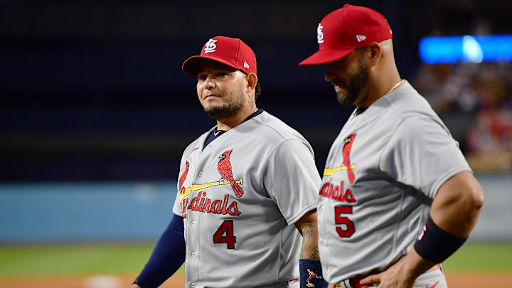 St. Louis Cardinals catcher Yadier Molina (4) and designated hitter Albert Pujols (5) react before receiving gifts from the Los Angeles Dodgers at Dodger Stadium on Sept. 23, 2022. St. Louis Cardinals catcher Yadier Molina (4) and designated hitter Albert Pujols (5) react before receiving gifts from the Los Angeles Dodgers at Dodger Stadium on Sept. 23, 2022.