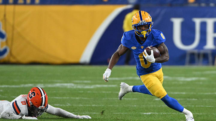 Oct 24, 2024; Pittsburgh, Pennsylvania, USA; Pittsburgh Panthers running back Desmond Reid (0) eludes Syracuse Orange defensive back Duce Chestnut (0) during the first quarter  at Acrisure Stadium. Mandatory Credit: Barry Reeger-Imagn Images