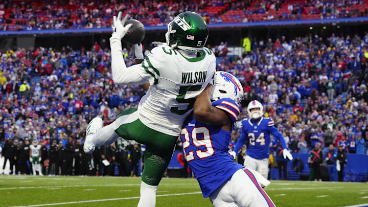 Dec 29, 2024; Orchard Park, New York, USA; New York Jets wide receiver Garrett Wilson (5) make a catch for a touchdown against Buffalo Bills cornerback Dee Delaney (29) during the second half at Highmark Stadium. Mandatory Credit: Gregory Fisher-Imagn Images