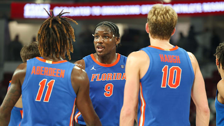 Feb 11, 2025; Starkville, Mississippi, USA; Florida Gators center Rueben Chinyelu (9) talks to guard Denzel Aberdeen (11) and forward Thomas Haugh (10) during the second half against the Mississippi State Bulldogs at Humphrey Coliseum. Mandatory Credit: Wesley Hale-Imagn Images